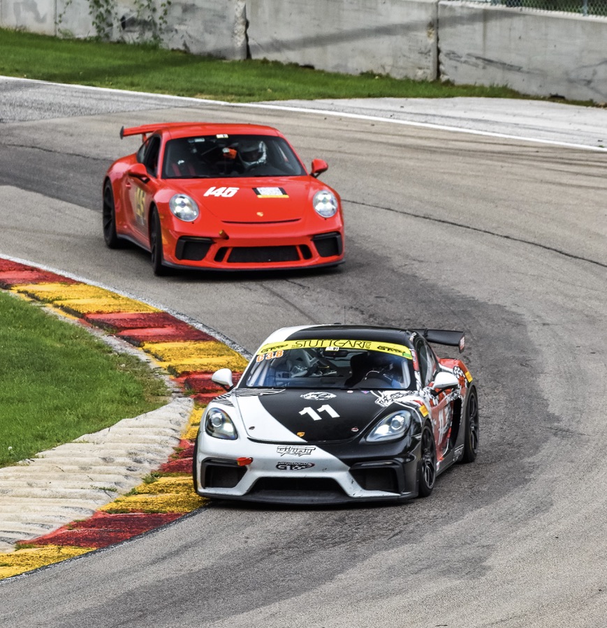 Porsche race cars at corner entry